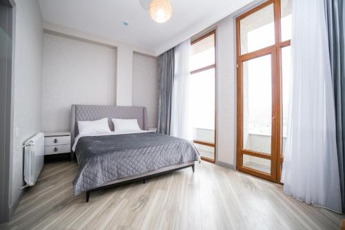 a bedroom with a bed and a large window at North Hotel in Qusar