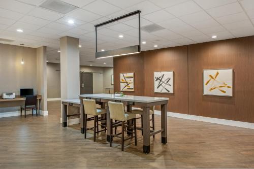an office lobby with a large table and chairs at Staybridge Suites Oxnard - River Ridge by IHG in Oxnard