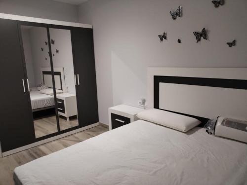 a bedroom with a bed and a large mirror at Castralvo Suites in Teruel