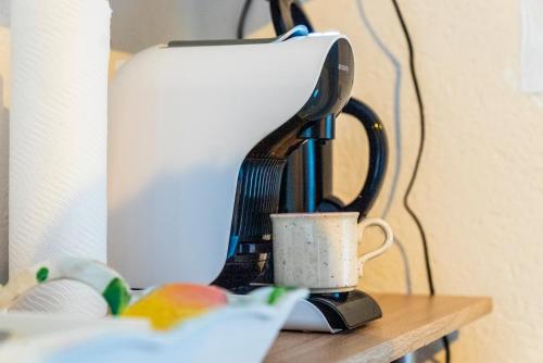 a coffee maker sitting on a table with a cup at Haus Frey in Altaussee