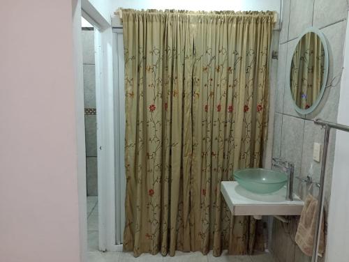 a bathroom with a shower curtain and a sink at Departamento el REPOSO in Guadalajara