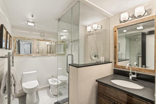 a bathroom with a toilet and a sink and a shower at Woodbridge Condo by Snowmass Vacations in Snowmass Village