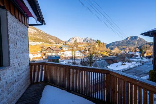 a balcony with a view of a town and mountains at Haus Frey in Altaussee