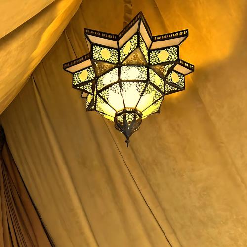 a chandelier hanging from a ceiling at Les Jardins D'issil in Marrakech