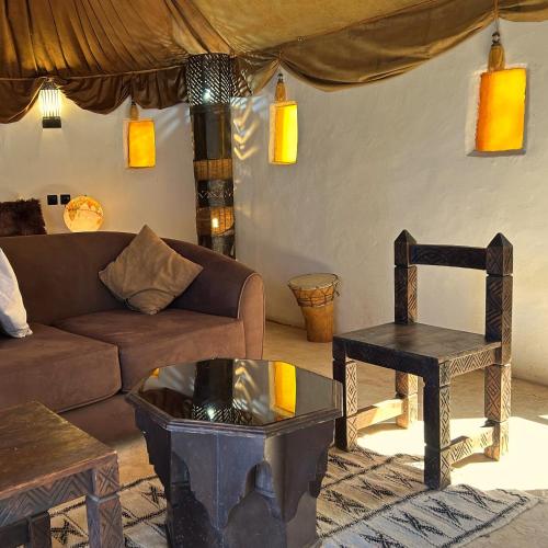 a living room with a couch and a chair at Les Jardins D'issil in Marrakech