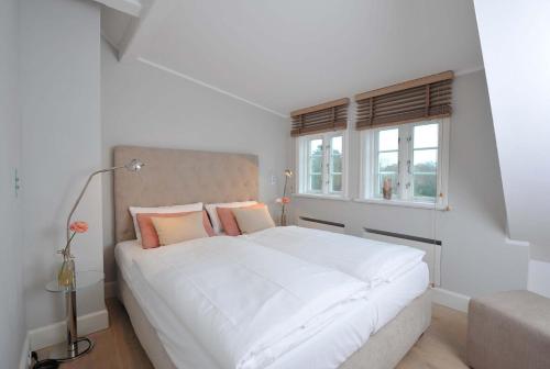 Giường trong phòng chung tại Munkmarscher Chaussee 7