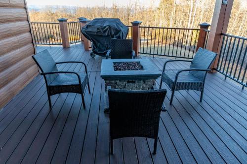 a deck with chairs and a table and a grill at Bear Paw Lodge - North Carolina in Boomer