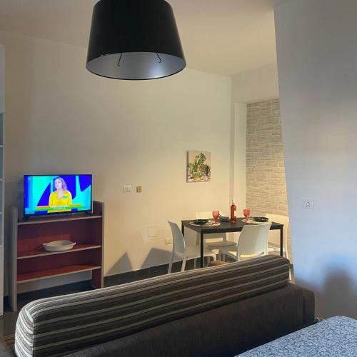 a living room with a table and a tv at Lalym in Rossano Stazione