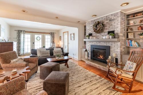 a living room with a couch and a fireplace at Quaint Elkton Home near Shenandoah National Park! in Elkton