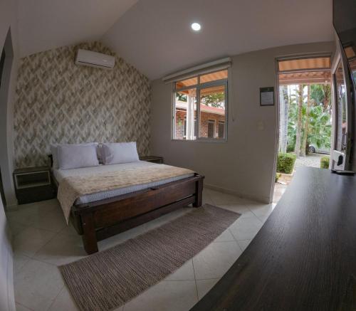 Ένα ή περισσότερα κρεβάτια σε δωμάτιο στο Hotel Campestre Palma Verde