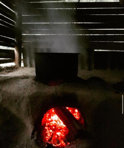 a fire pit with a red object on the ground at Miknaon River Retreat in Pedong