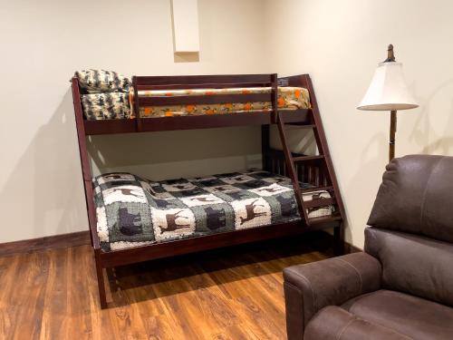 a childs bunk bed in a room with a couch at Bear Paw Lodge - North Carolina in Boomer