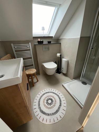 a bathroom with a sink and a toilet and a window at Ostsee-AuszeitDahme in Dahme