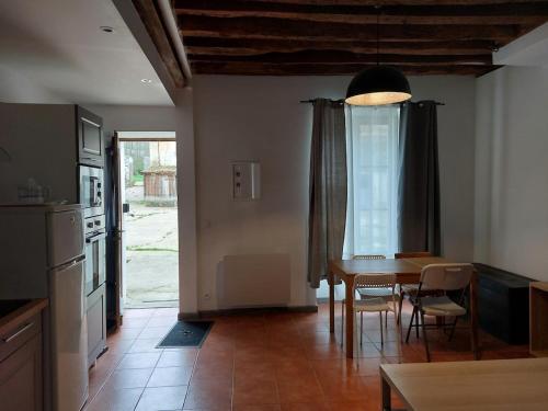 a kitchen and dining room with a table and chairs at Ground floor apartment in farmhouse in Villiers-le-Bâcle