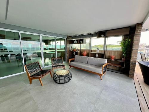 a living room with a couch and chairs at RN Studios Premium Apt 805 - Mandi Hospitalidade in Maceió