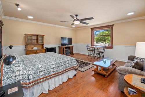 a bedroom with a bed and a couch and a tv at Lewis Loft in Paso Robles