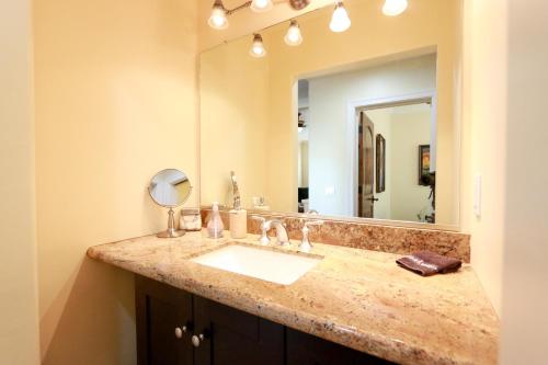 a bathroom with a sink and a mirror at Olive with a Twist in Paso Robles