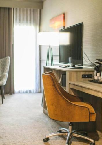 a chair in a room with a flat screen tv at The Ridges Resort on Lake Chatuge in Young Harris