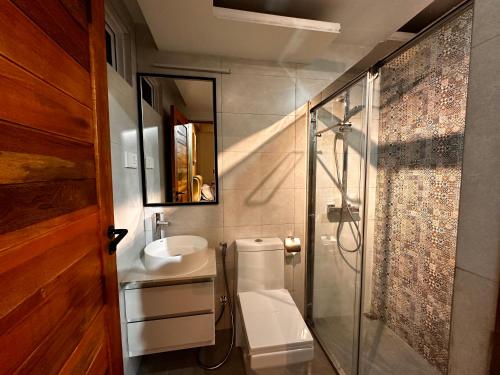 a bathroom with a toilet and a sink and a shower at Bahee Residence in Kulhudhuffushi