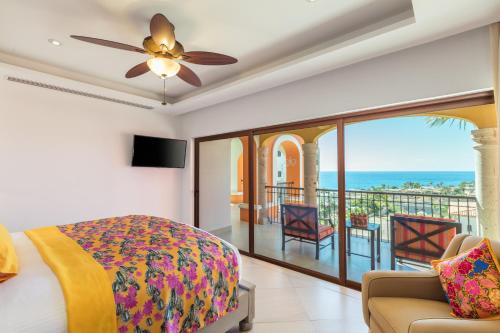 a bedroom with a bed and a balcony with the ocean at Vista Encantada Resort & Spa Residences, A La Carte All Inclusive Optional in Cabo San Lucas