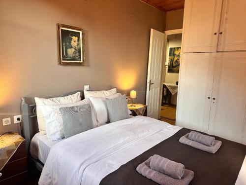 a bedroom with a large bed with two towels on it at Grandma's place in Arachova
