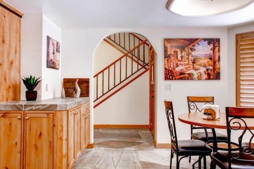 a kitchen with a table and a stairway at Hacienda in Solitude Vineyard in Paso Robles