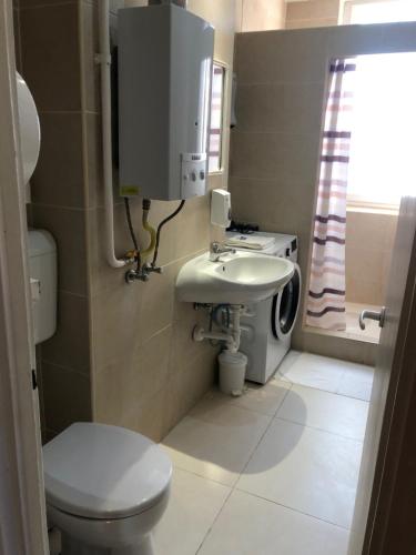 a small bathroom with a toilet and a sink at Home in Zalaegerszeg