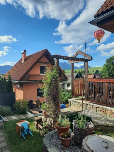 a backyard with a wooden deck and a house at Domceky Holiday in Liptovský Trnovec