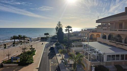 a view of a beach with a building and the ocean at Casa Marie in Marina di Modica