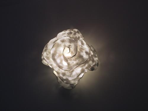 a silver object with a smoke pattern on a black background at Relais12bis Bed & Breakfast By Eiffel Tower in Paris