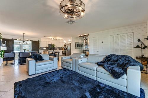 a living room with two couches and a rug at 1 Mi to Bonita Beach Park Chic Canal-Front Home! in Bonita Springs
