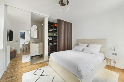 - une chambre blanche avec un grand lit et un salon dans l'établissement 2 room Apartment - 16th, à Paris