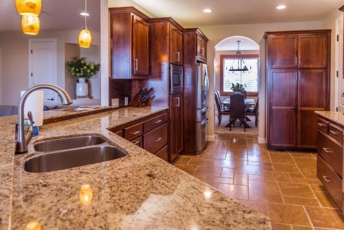 a kitchen with a sink and a refrigerator at Red Cloud Rendezvous in Paso Robles