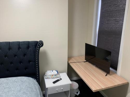 a bedroom with a bed and a desk with a television at Beautiful bedroom next Camden yard and M&T stadium in Baltimore