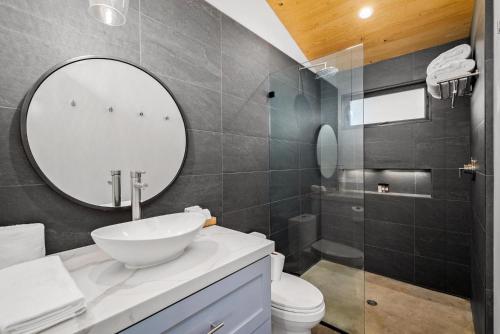 a bathroom with a sink and a mirror at Cocavin Carriage House in Paso Robles