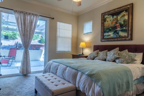 a bedroom with a bed and a sliding glass door at Ritz Del Rio in Paso Robles