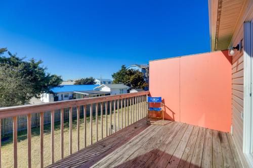 a balcony of a house with an orange wall at Walk to Atlantic Beach Townhome with Patio! in Atlantic Beach