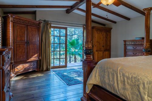 a bedroom with a bed and a large window at San Antonio Estate in Atascadero