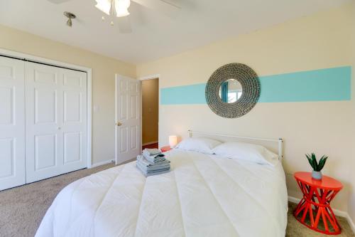 a bedroom with a white bed and a red table at half Mi to Atlantic Beach Townhome with Balcony! in Atlantic Beach