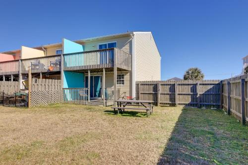 a house with a picnic table and a fence at half Mi to Atlantic Beach Townhome with Balcony! in Atlantic Beach