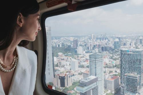 a woman is looking out the window of a train at The St. Regis Mexico City in Mexico City