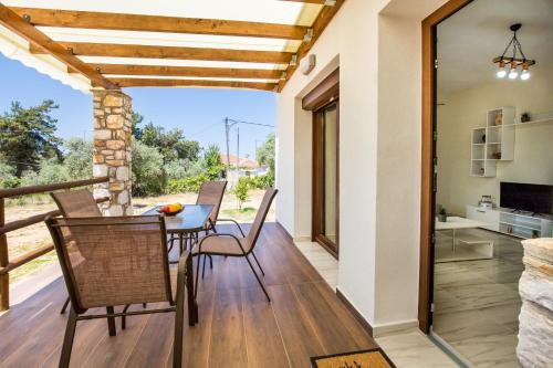 a dining room with a table and chairs on a deck at Zara Studios in Astris