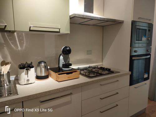 a kitchen with a stove and a counter top at Foder'House Design Suite in Agrigento