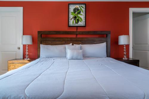 a bedroom with a large bed with red walls at Estrella Vineyard in San Miguel