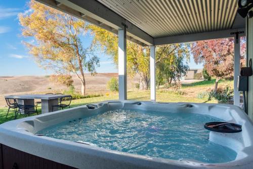 a jacuzzi tub on a patio with a table at Sunset at Nirvana in San Miguel