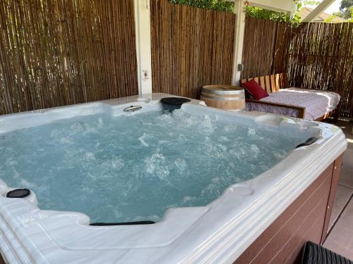 a large jacuzzi tub on a patio with a chair at Sea Rock Ranch in Templeton