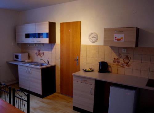 a kitchen with a sink and a counter top at Apartment Patera in Unhošť
