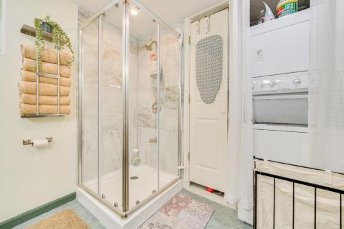 a shower with a glass door in a bathroom at 9 Mi to Snowmobile Trails! Home Near Mullett Lake in Cheboygan