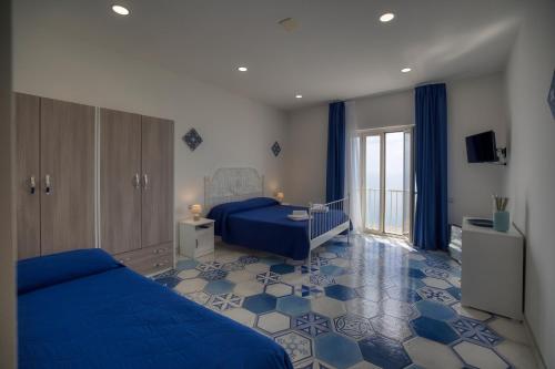 a bedroom with a blue bed and a blue floor at Tenuta La Picola in Furore