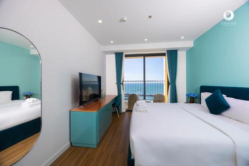 a hotel room with two beds and a television at Luna Sol Villas - Dedicated Care Until Check Out in Phu Quoc